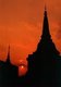 Thailand: The sun sets over the spires of a Chiang Mai temple, northern Thailand